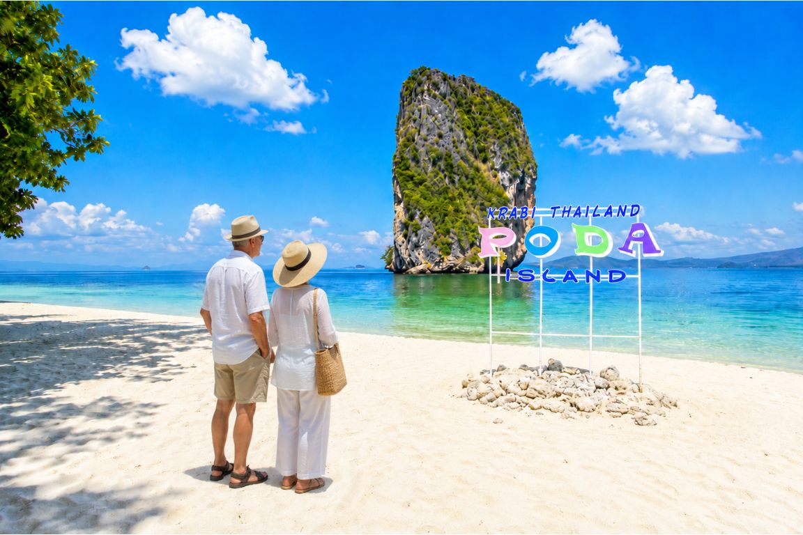 Couple admiring the iconic limestone rock formation at Poda Island during a Krabi Boat Tours day trip